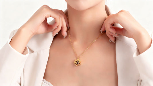 A model wore a necklace pendant featuring a pet's paw print.