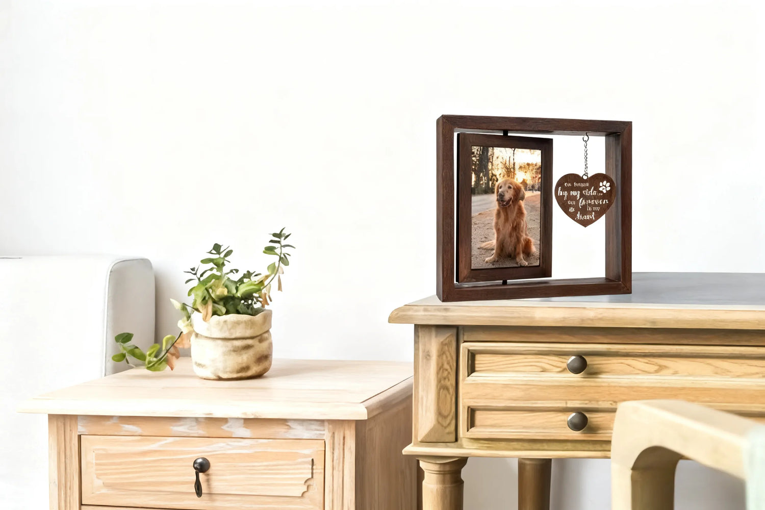 A rotating double-sided pet keepsake photo frame is placed on the living room table.