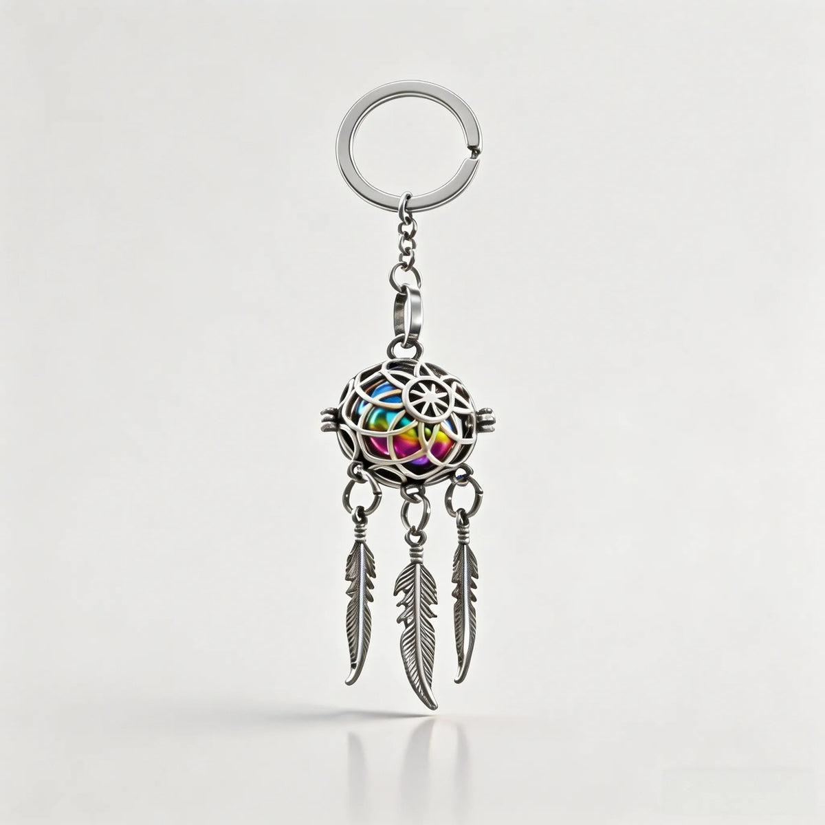 Silver pet memorial dreamcatcher keychain with feather charms on a white background