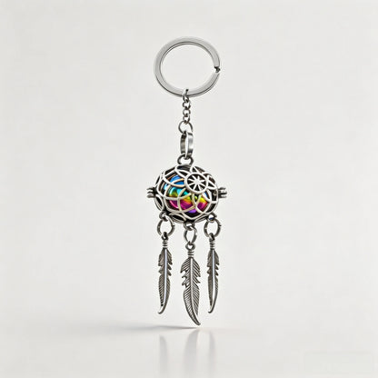 Silver pet memorial dreamcatcher keychain with feather charms on a white background